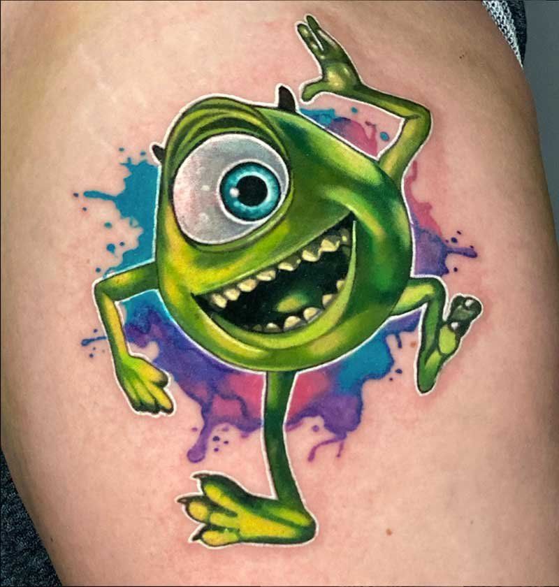 A tattoo of mike from monsters inc on a person 's arm