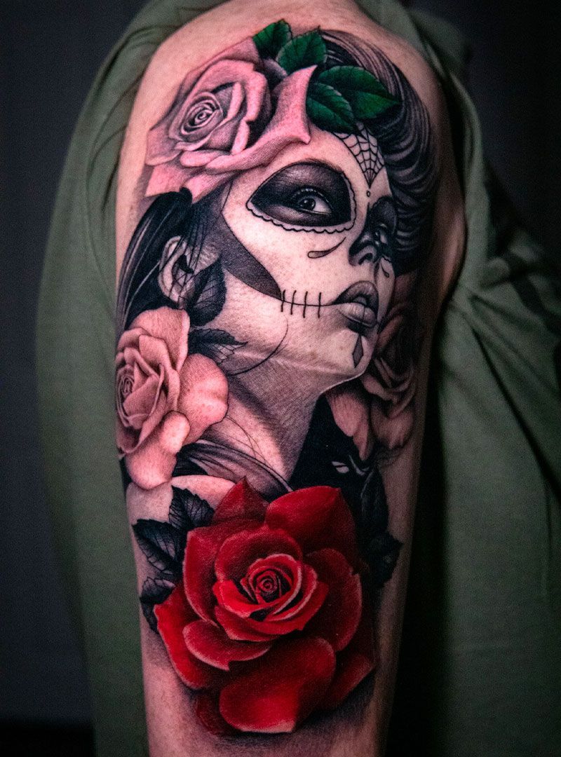 Tattooed portrait with a black eye, pink flowers, and a red rose on the arm