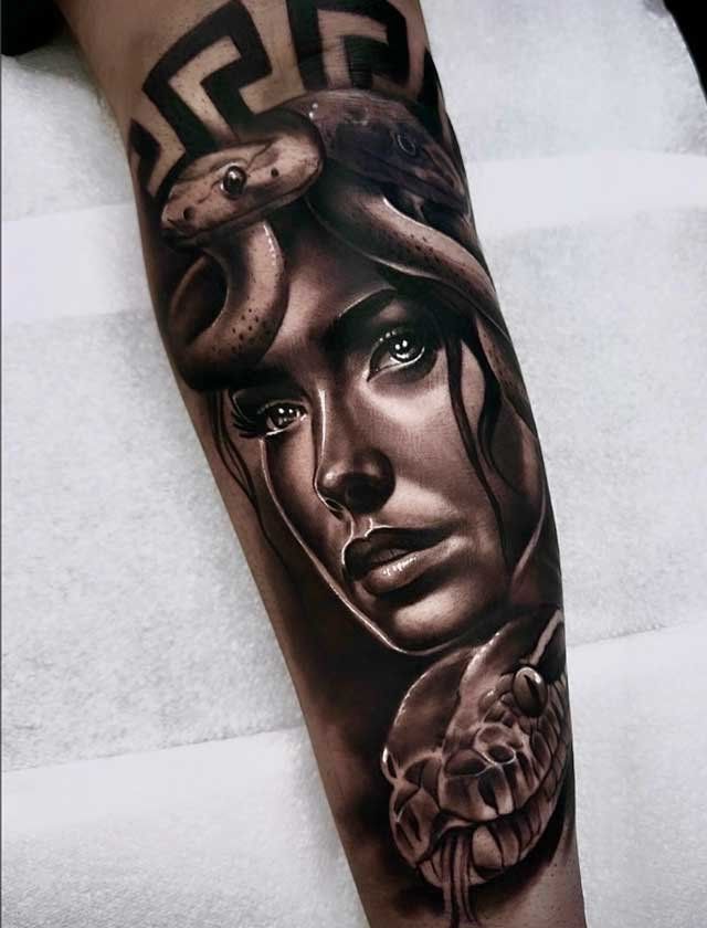 A tattoo of a woman with a snake around her head