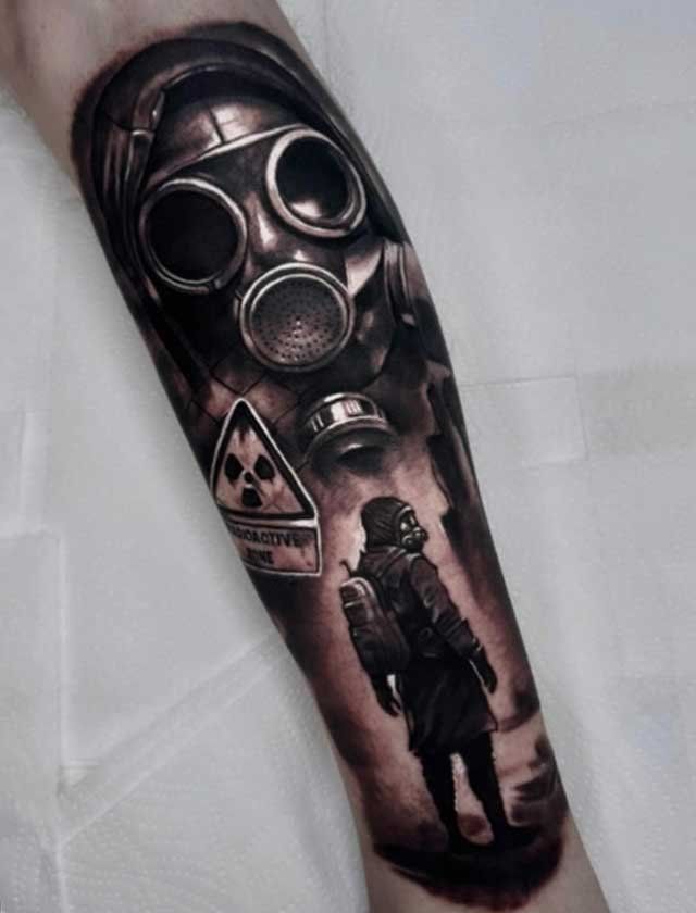 A tattoo of a man wearing a gas mask on his forearm.
