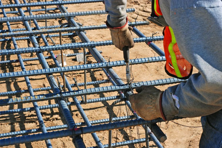 Worker tie steel and rebar