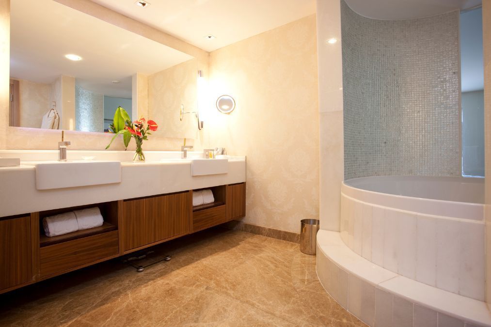 Corner bath in newly remodelled bathroom where the dual basins were added to level up the overage feel and value of the bathroom.