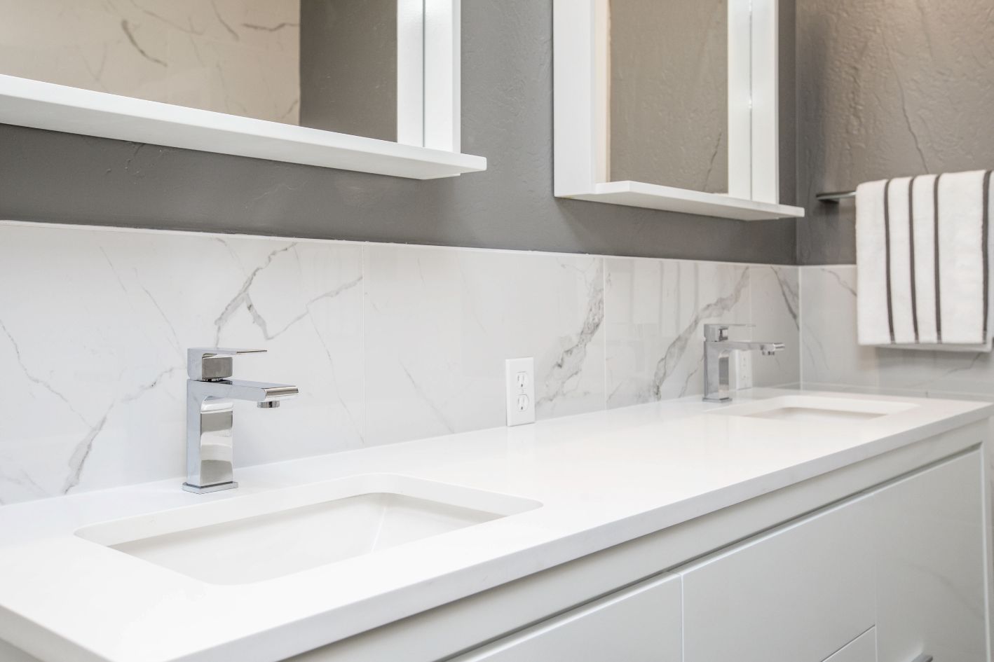 Two sinks in a white bathroom.