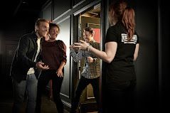 Escape room successful exit with people celebrating their victory of the Escape Hunt.