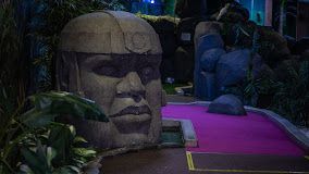 Statue made from stone in purple crazy adventure golf course.
