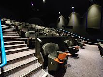 Luxurious cinema room with chairs and stairs.