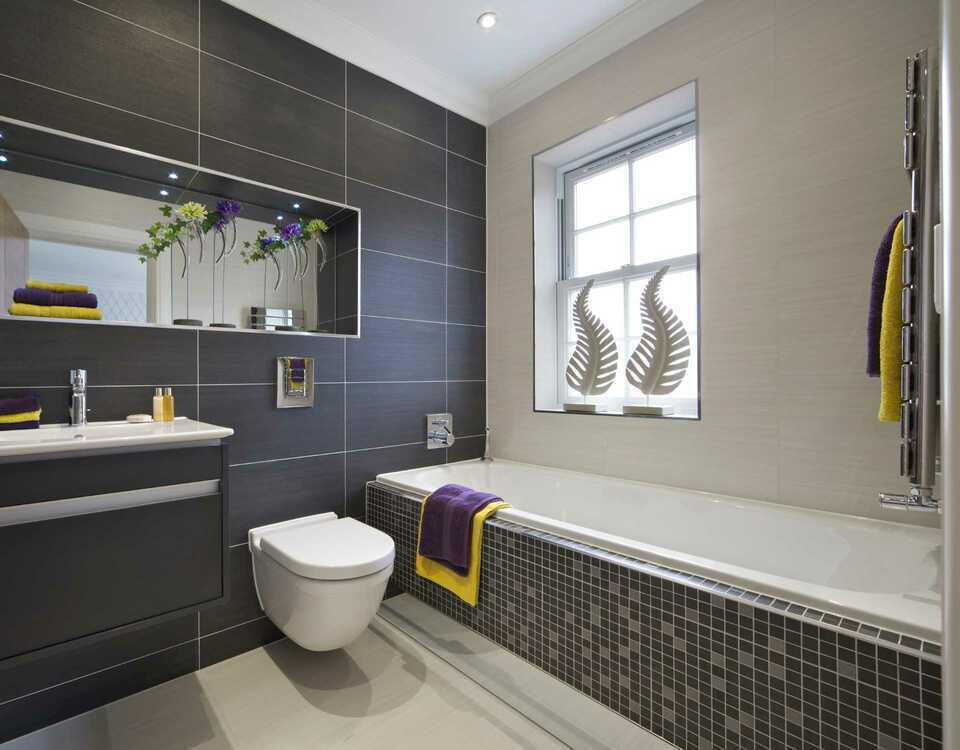 Modern bathroom with a grey theme including a sliding shower, one sink and two drawers.