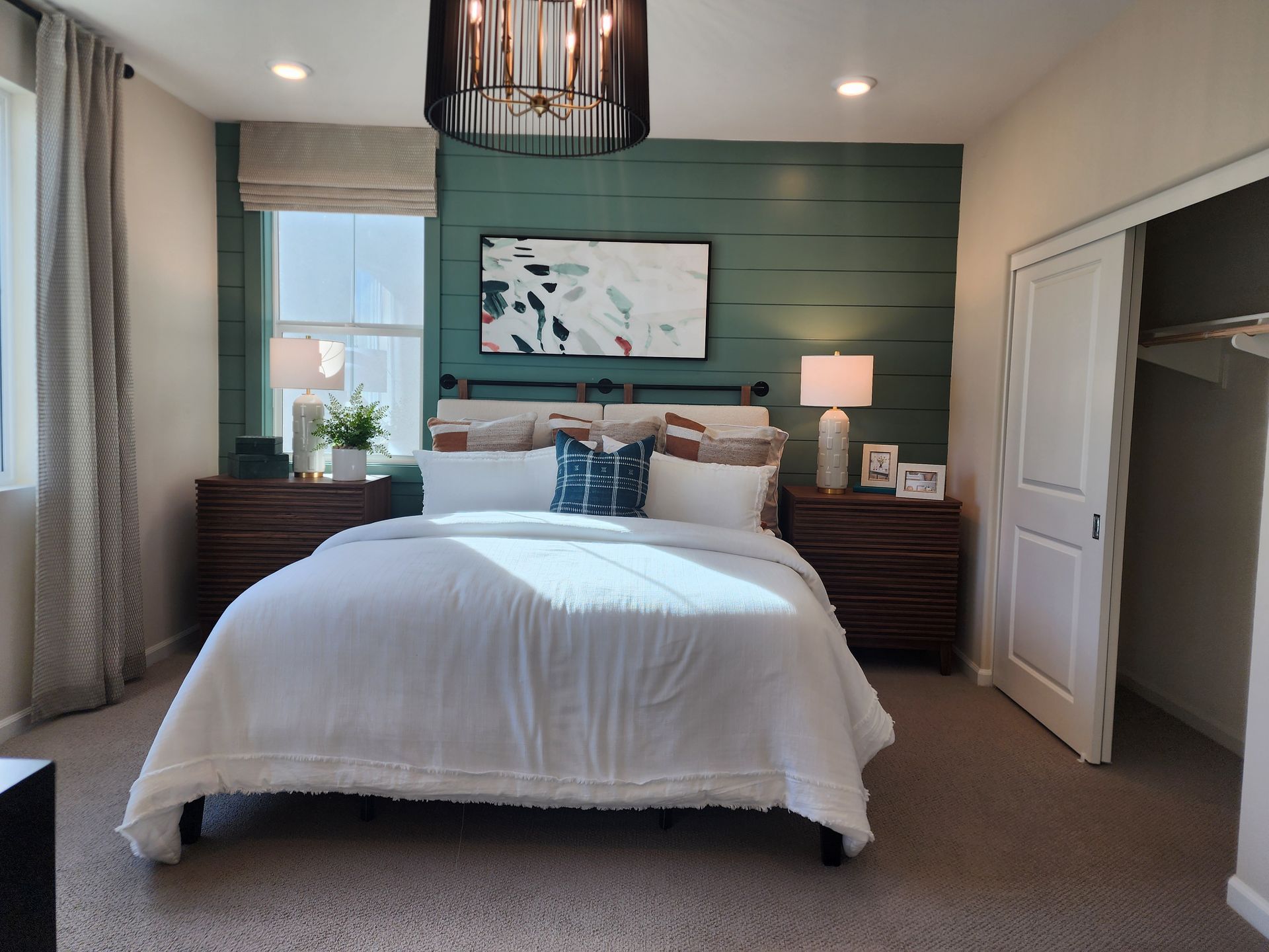 A bedroom with a large bed and a green wall.