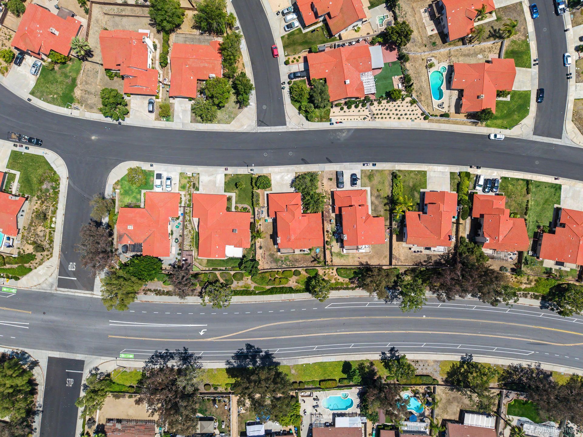 Top-down drone view of a Sunnymead Ranch neighborhood showing tile-roof single-family homes, yards, 