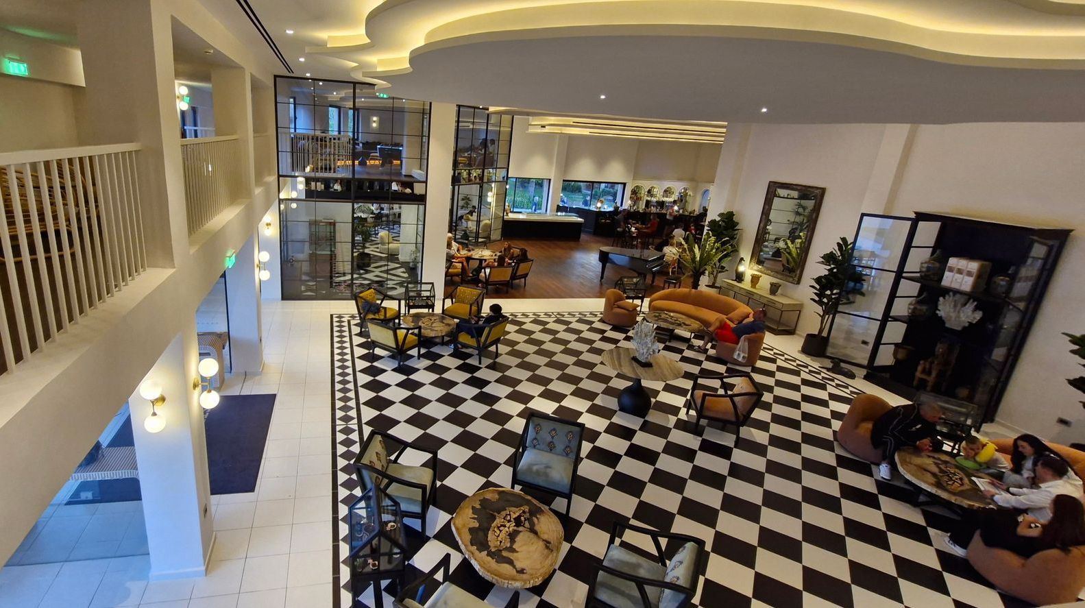 An aerial view of a hotel lobby with a checkered floor.