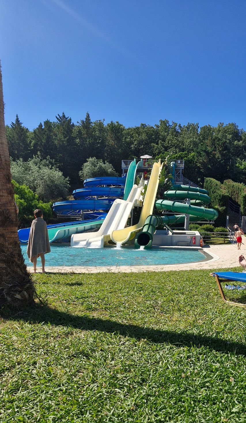 A water park with a lot of water slides and a pool.