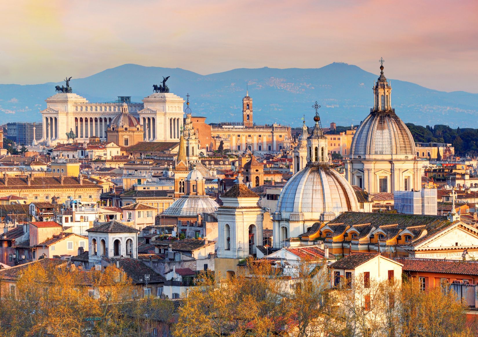 Rome An aerial view of the city of rome with mountains in the background.