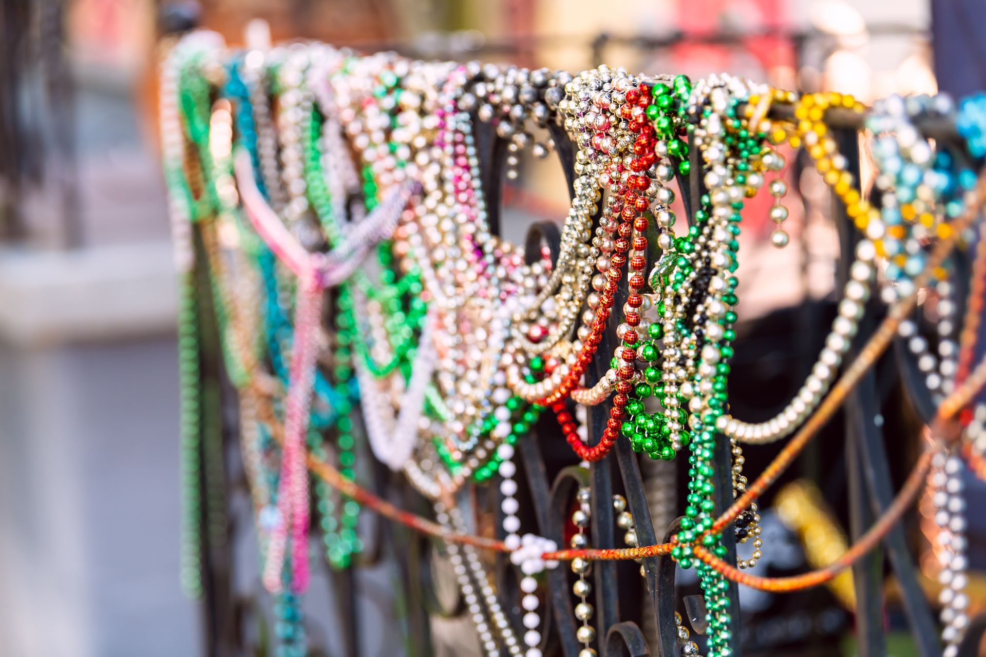 Colorful beaded necklaces hanging on display racks at a market stall