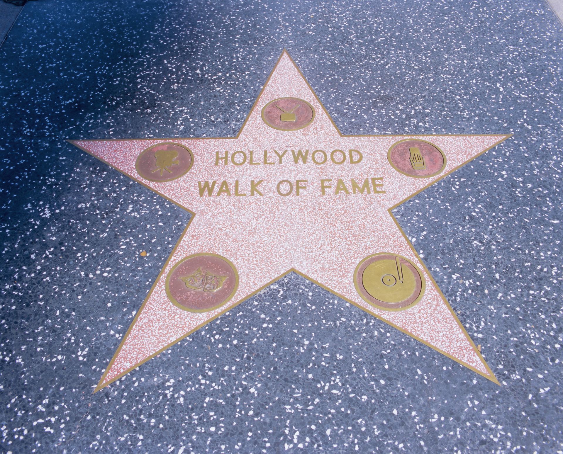 Hollywood Walk of Fame star on a glittery sidewalk with brass medallions
