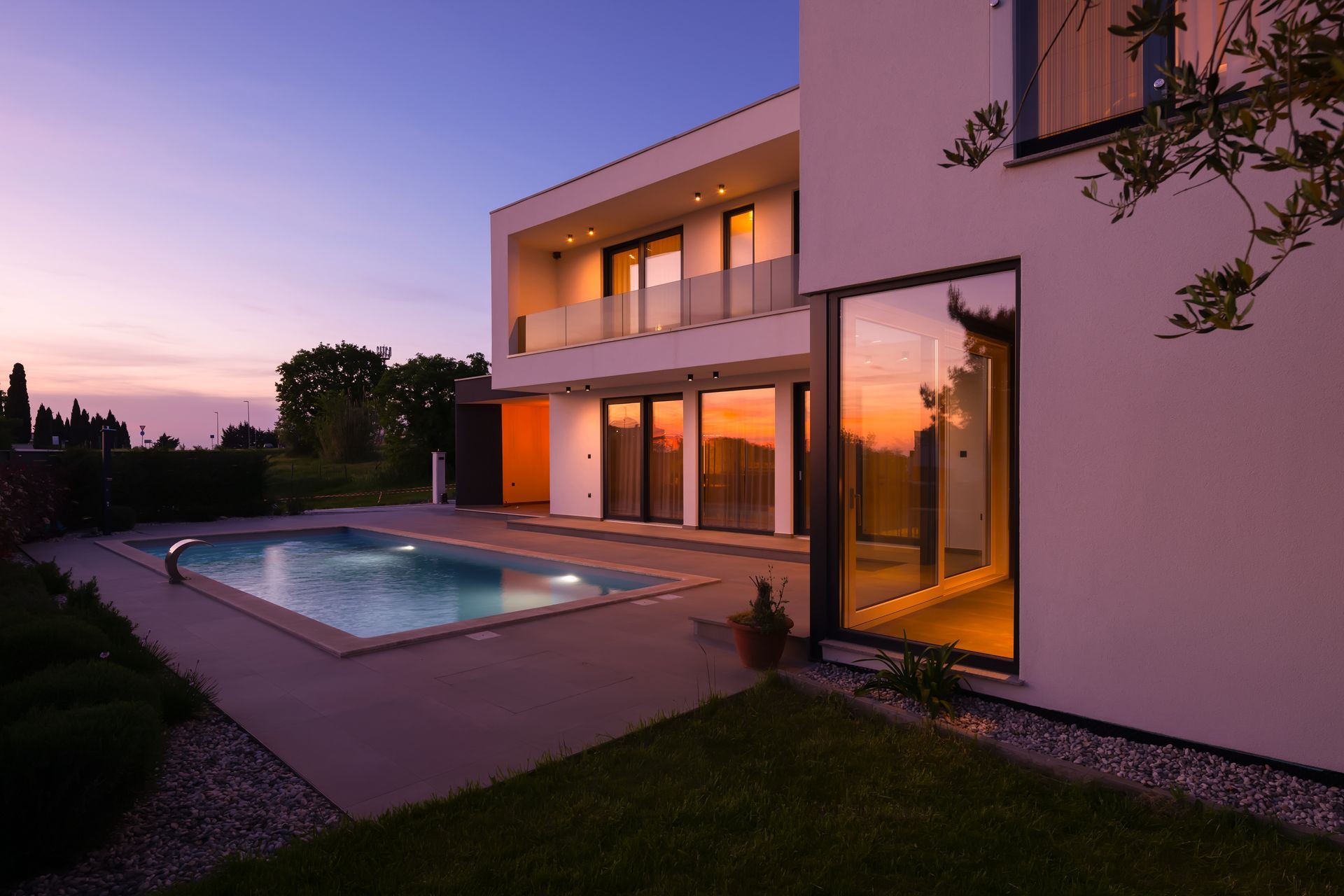 Sunset casting warm light over a tranquil villa and reflective pool. Overlay Text: Villa Breaks 