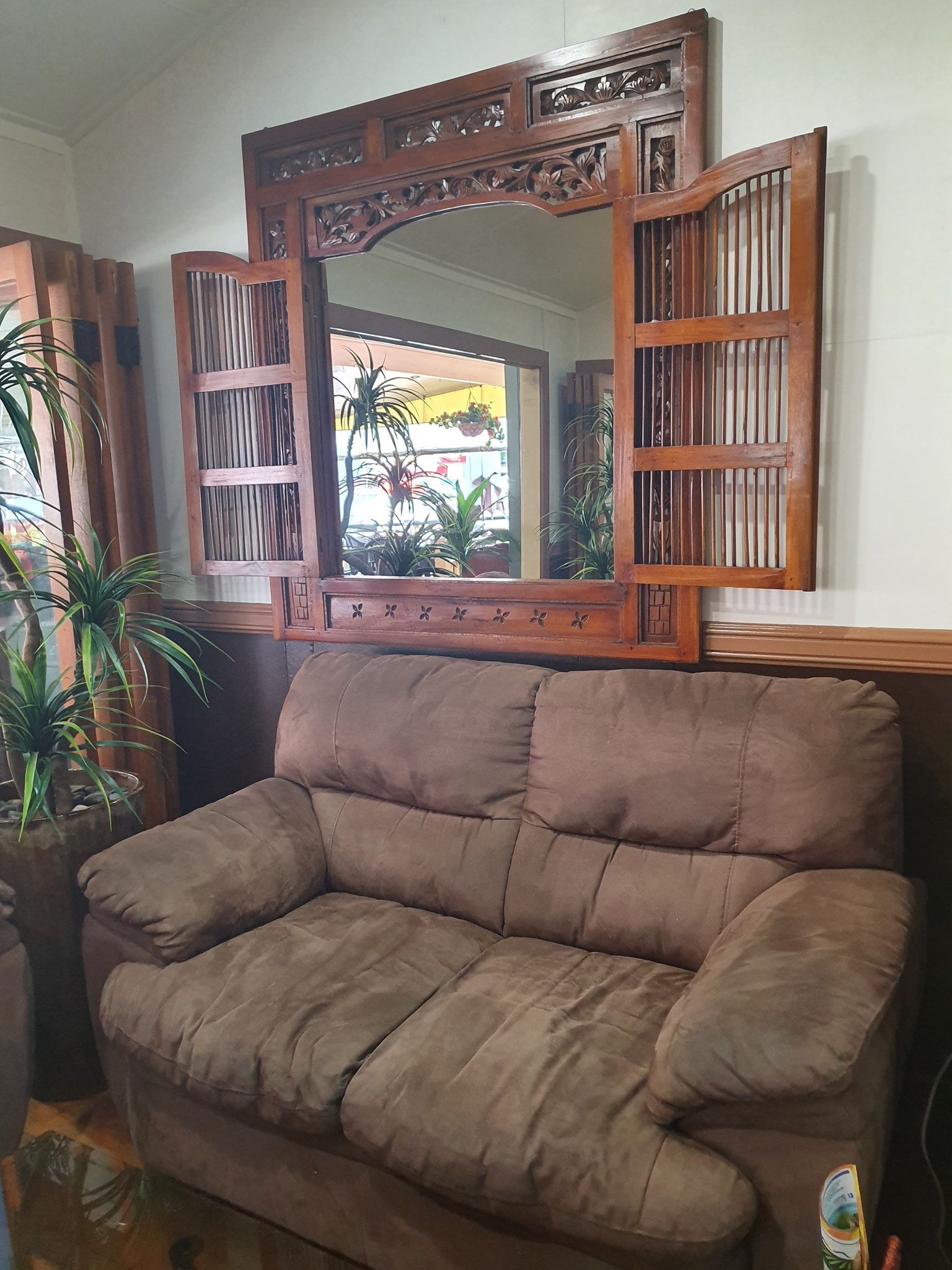 Brown Sofa Beneath a Large Wooden Mirror — Kape Centro In Childers, QLD 