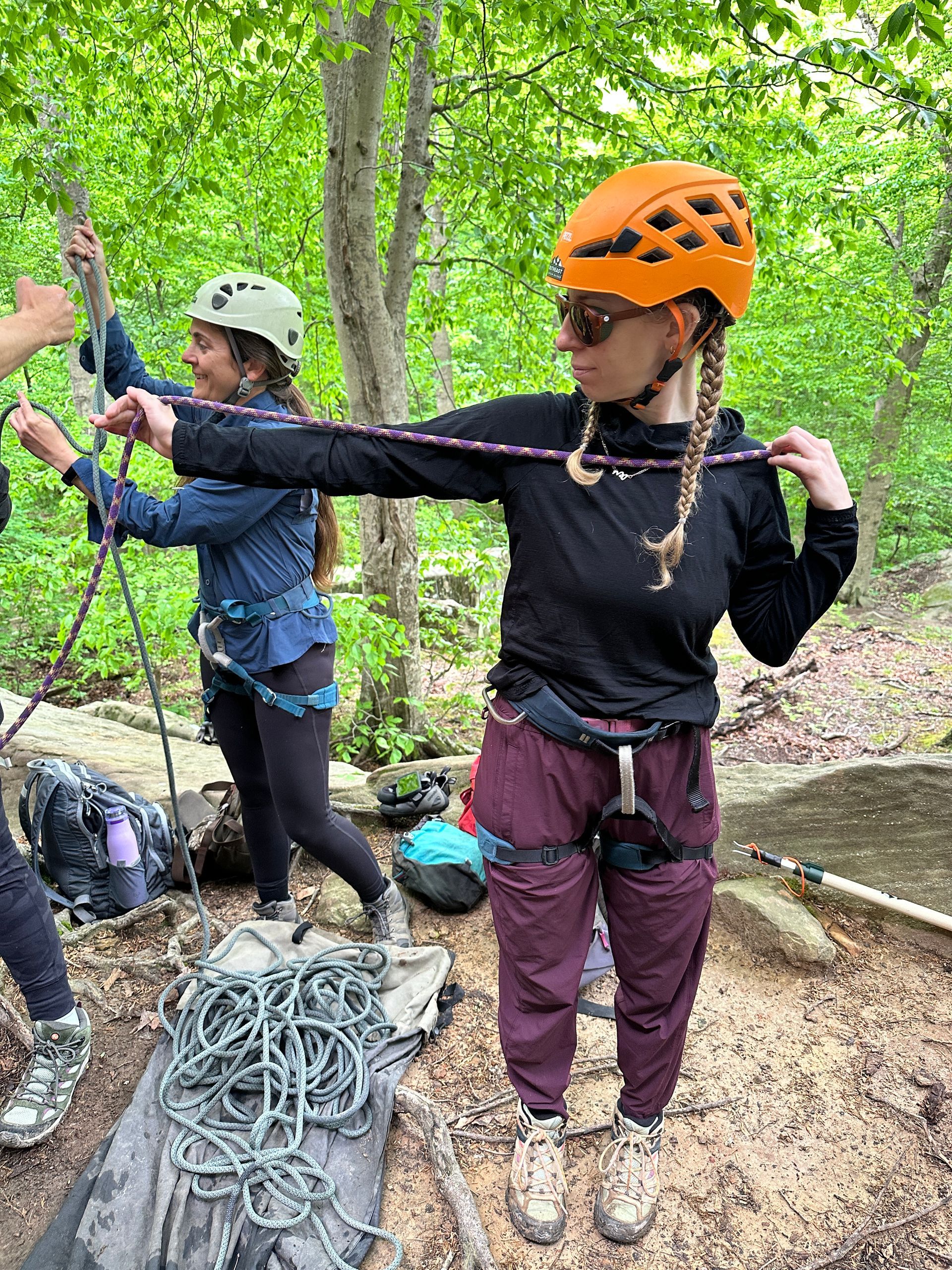 climber dressed in breathable layers with their harness on preparing to climb in the red river gorge