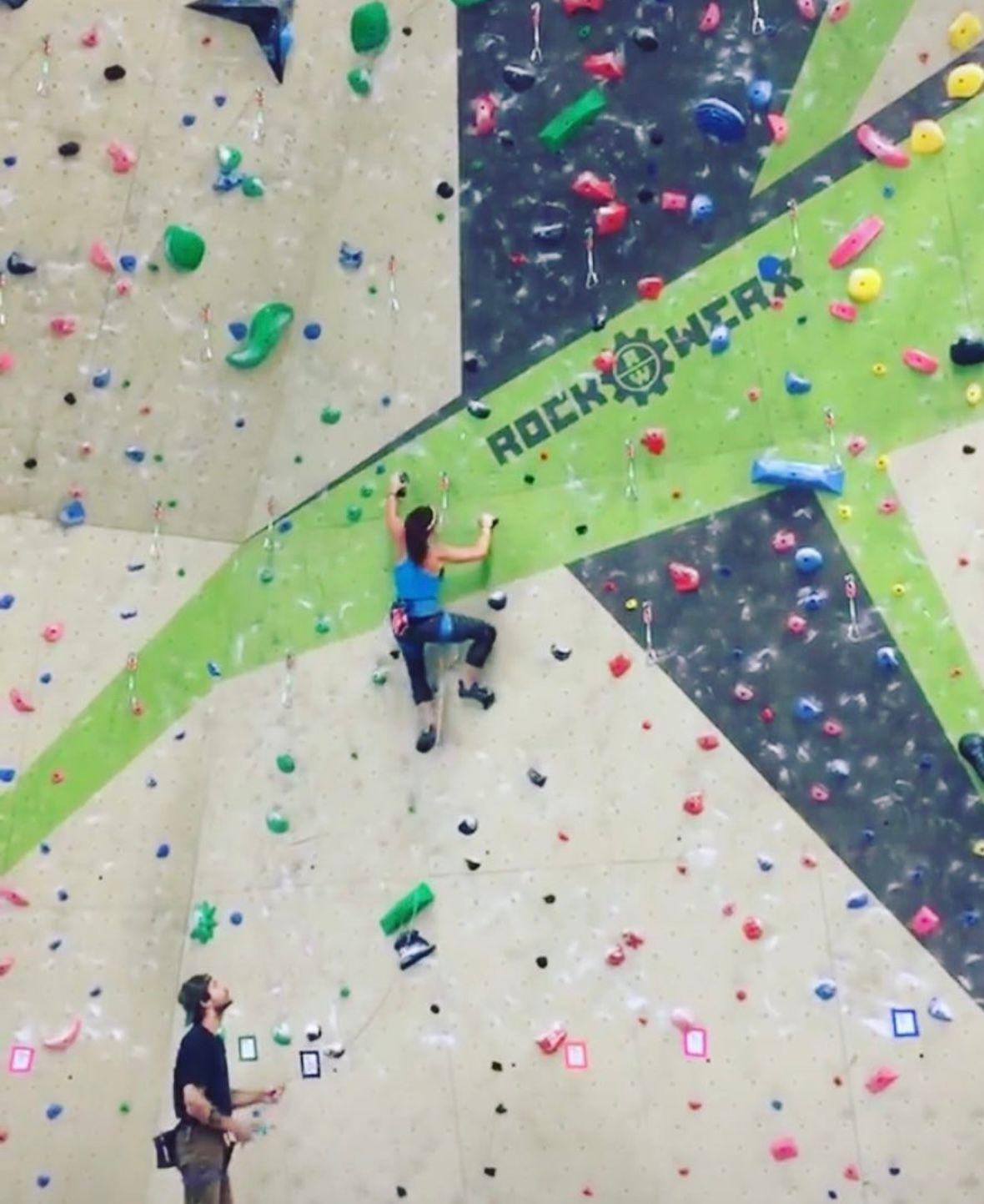 Lead Climber reading a route in a climbing gym | learn to climb outside