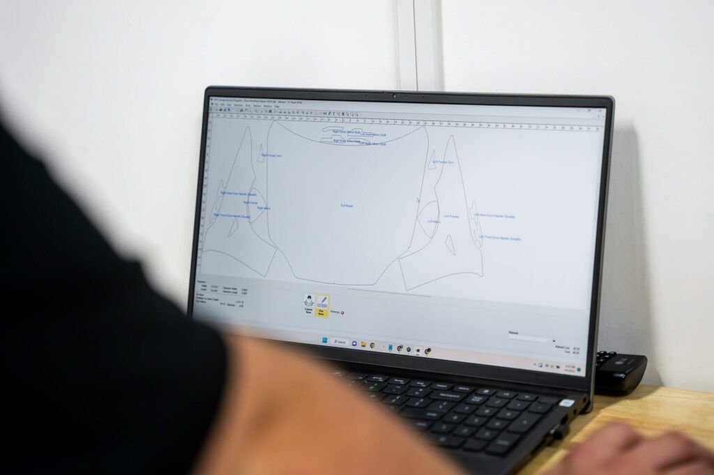 A person is using a laptop computer with a graph on the screen.