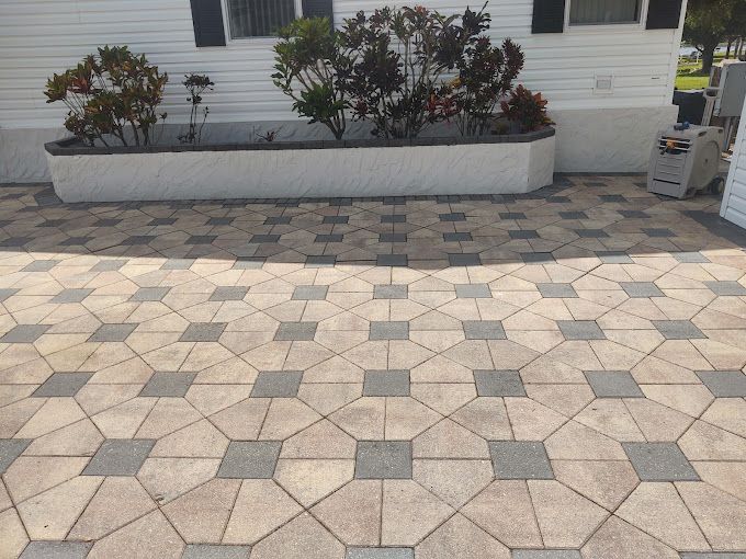 A patio with a planter in the middle of it