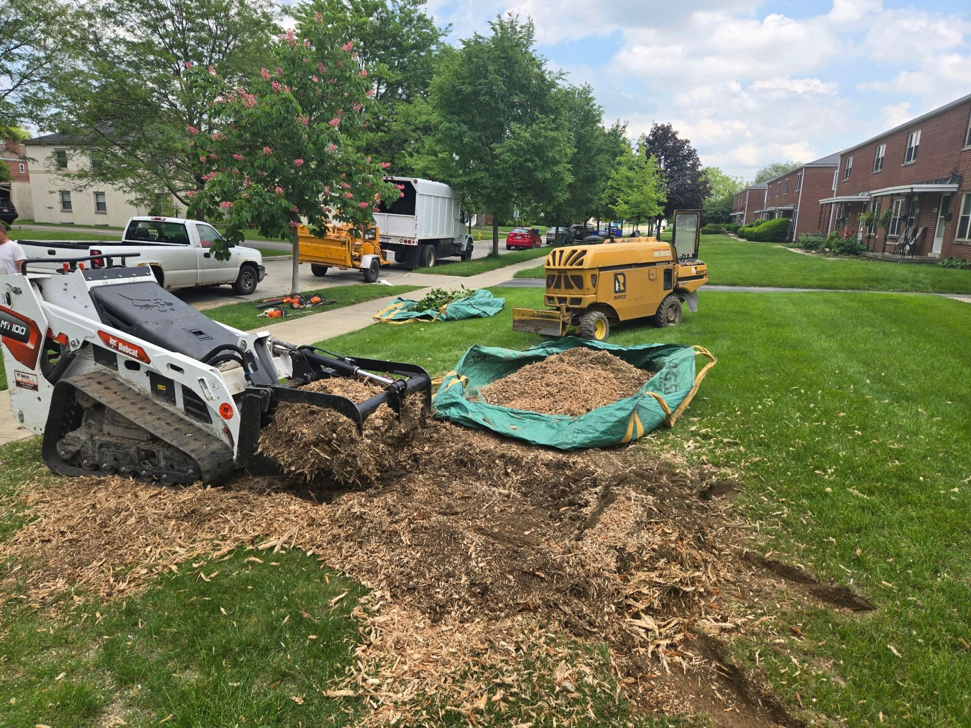 A stump grinder is being used to remove a tree stump.