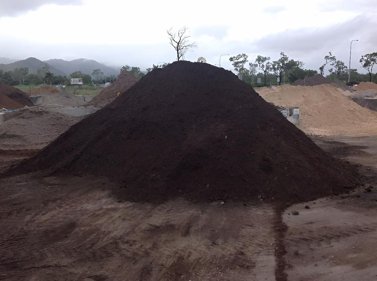 A Large Pile Of Dirt Is Sitting On Top Of A Dirt Field — Scott Kennedy's Landscape & Garden Supplies In Shaw, QLD