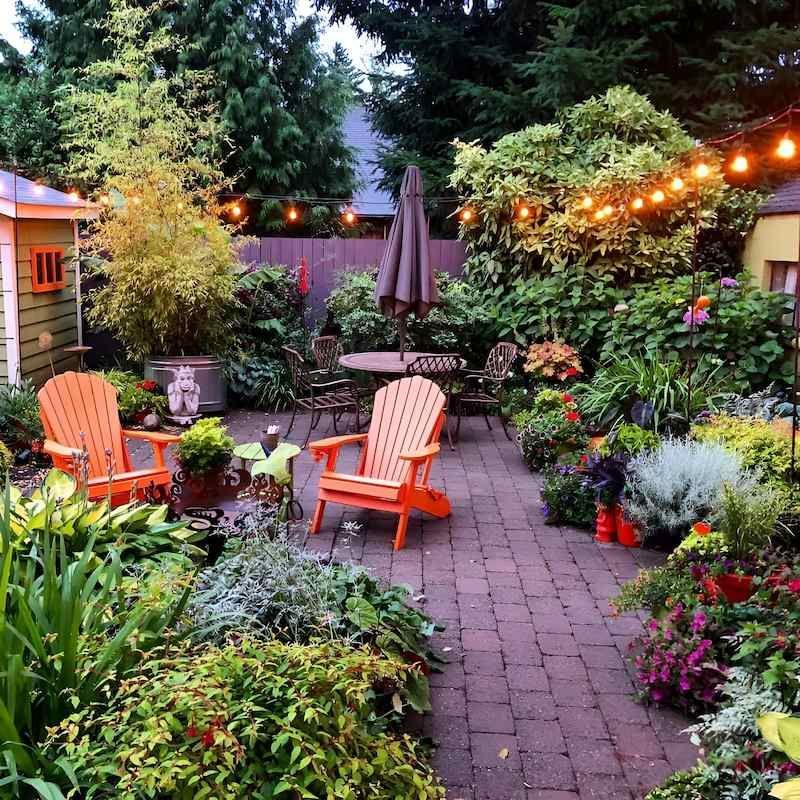 A Patio With A Table And Chairs And A String Of Lights — Scott Kennedy's Landscape & Garden Supplies In Shaw, QLD