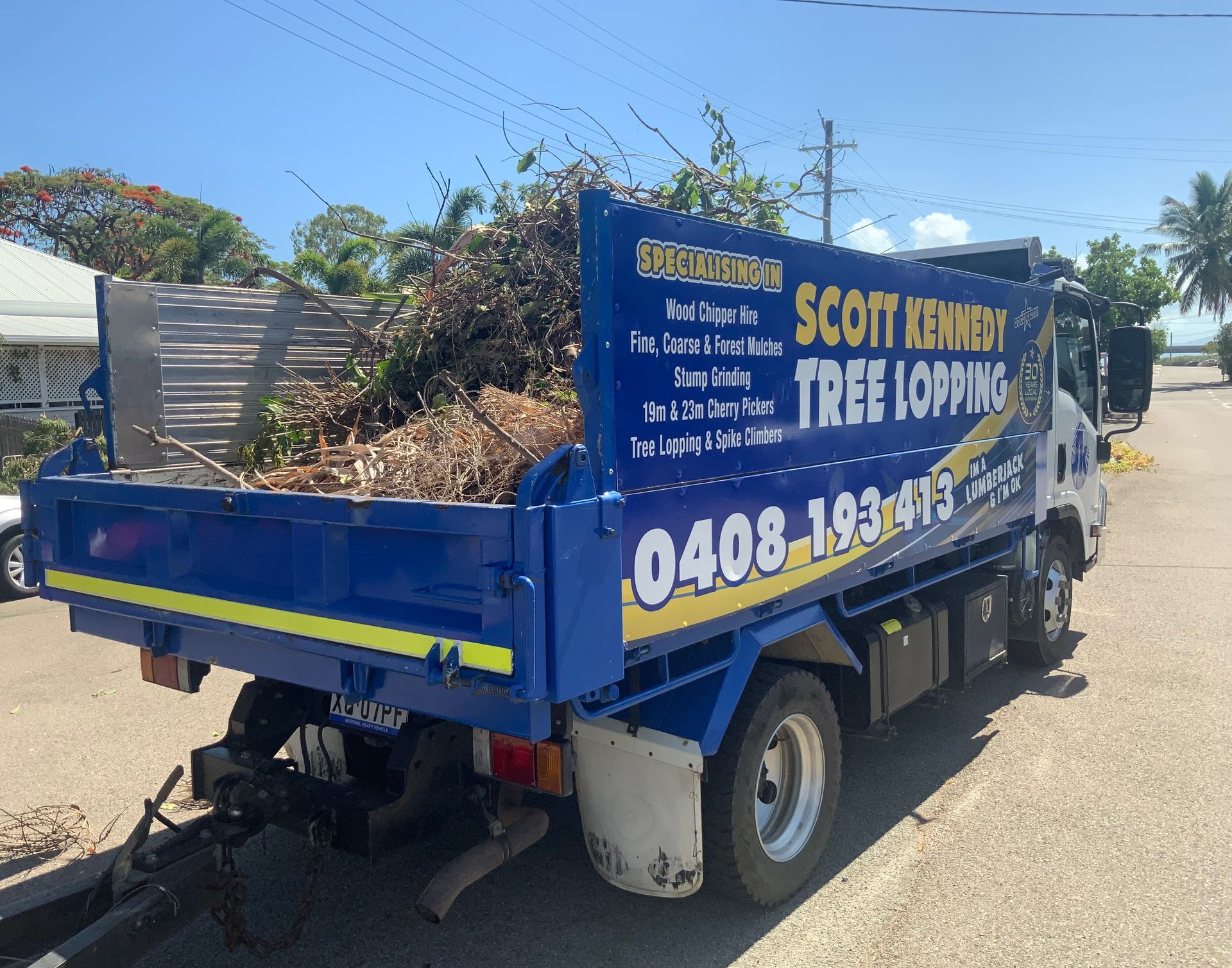 A Truck Filled With Tree Clippings Parked On A Road— Scott Kennedy's Landscape & Garden Supplies In Shaw, QLD