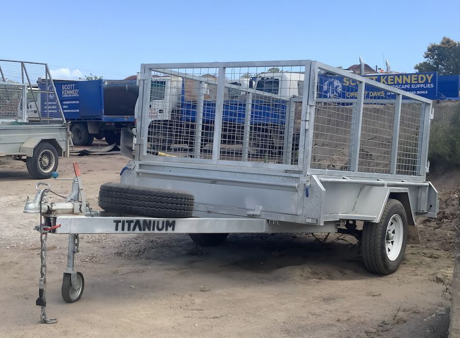 A Titanium Trailer Is Parked In A Dirt Lot Next To A Truck — Scott Kennedy's Landscape & Garden Supplies In Shaw, QLD