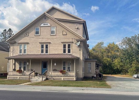 White two-story house rental property in Sugar Hill, NH by Loveless Family Properties