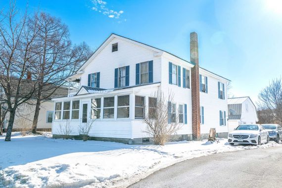 White two-story house rental property in Sugar Hill, NH by Loveless Family Properties