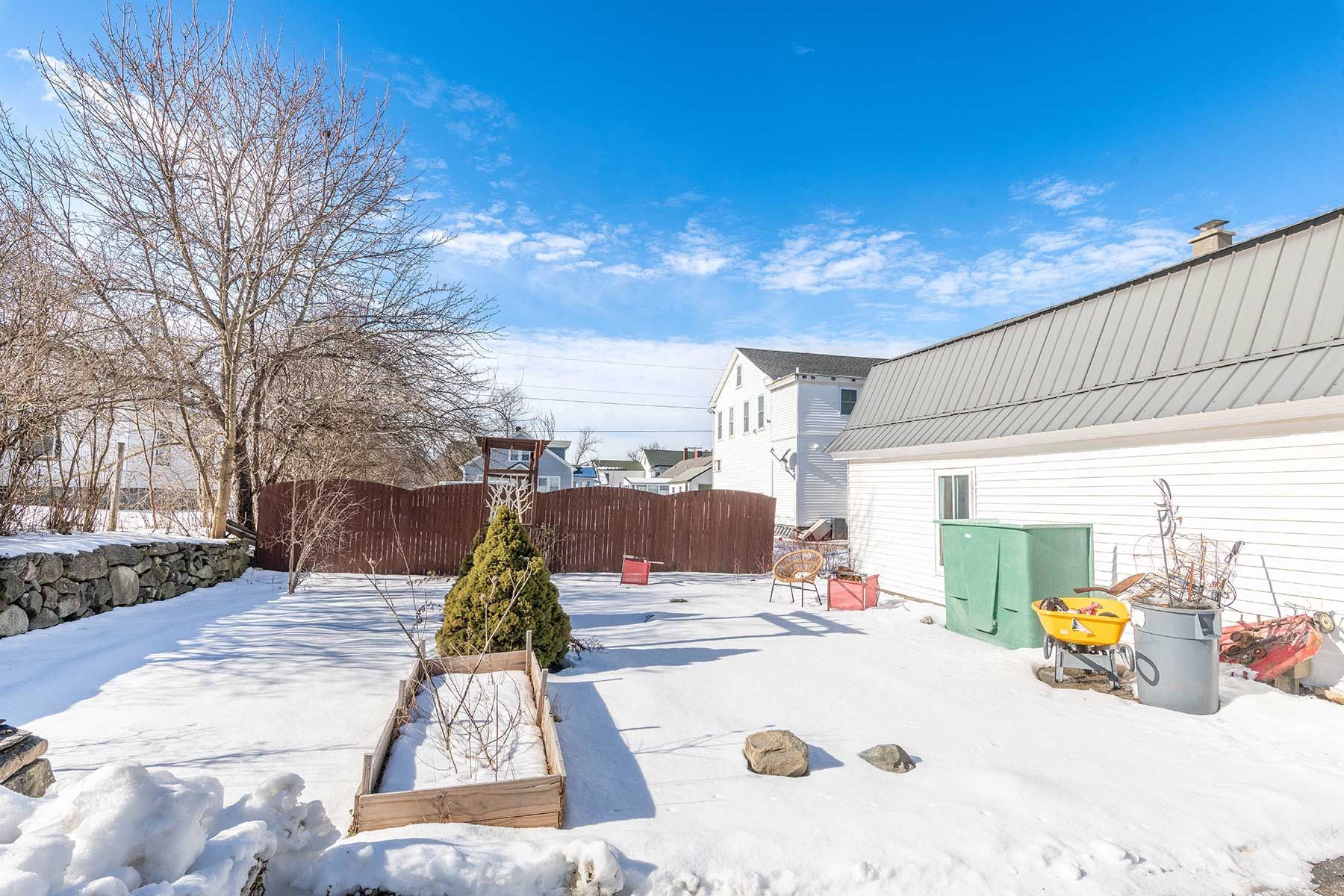 Backyard with raised garden bed at the Union Street duplex, Littleton NH