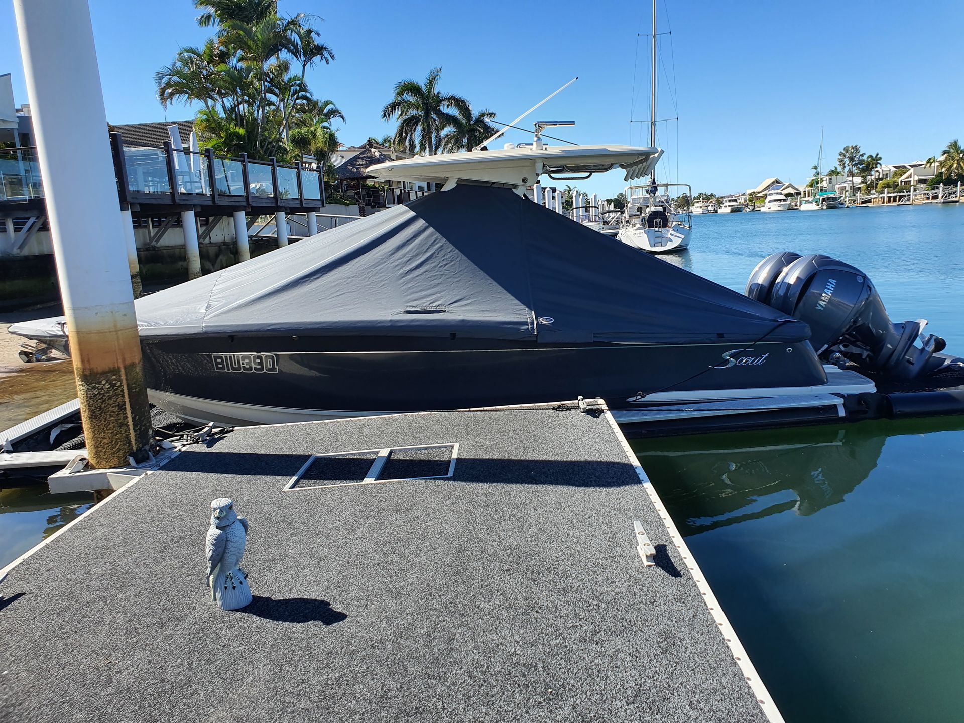 A Boat is Docked at a Dock Next to a Body of Water — The Boat Cover Company In Buddina, QLD