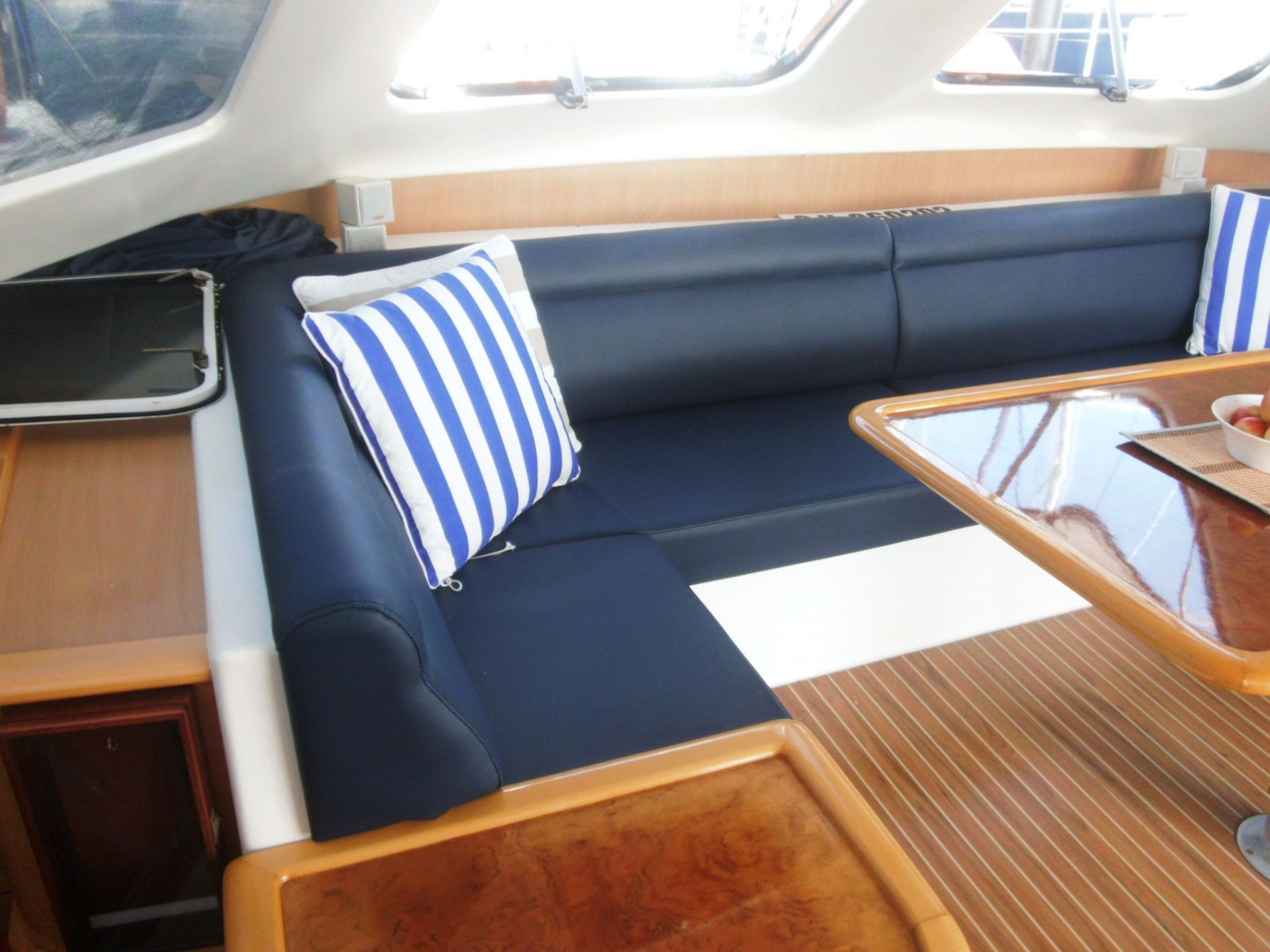 A  Couch With Blue and White Striped Pillows on It — The Boat Cover Company In Buddina, QLD