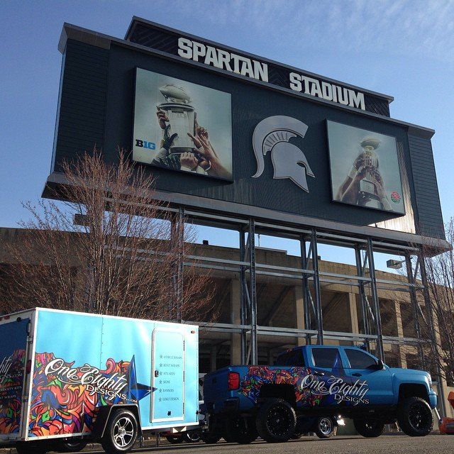 Spartan stadium with a truck and trailer parked in front of it
