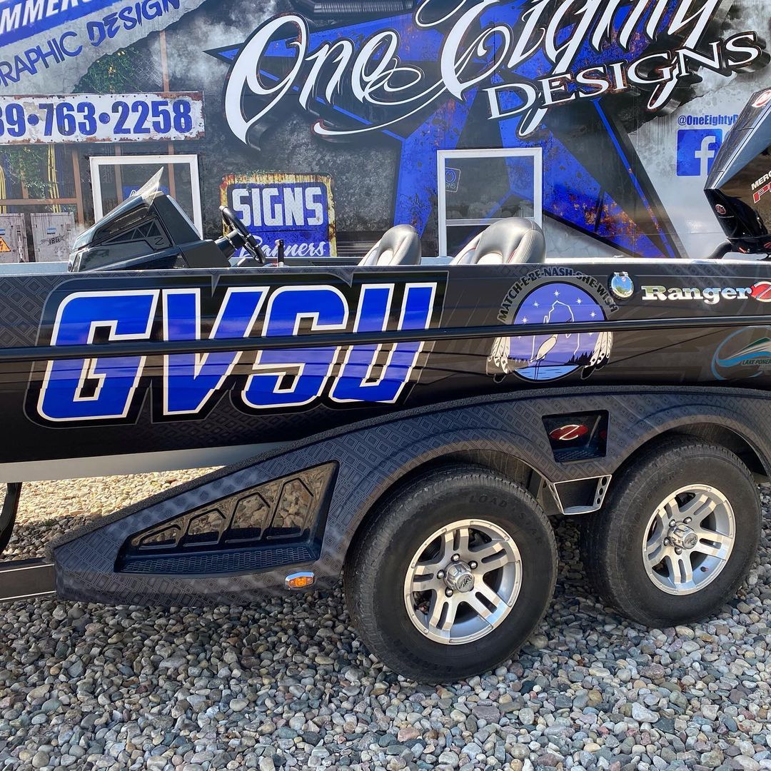 A boat with the word gvsu on it is on a trailer.