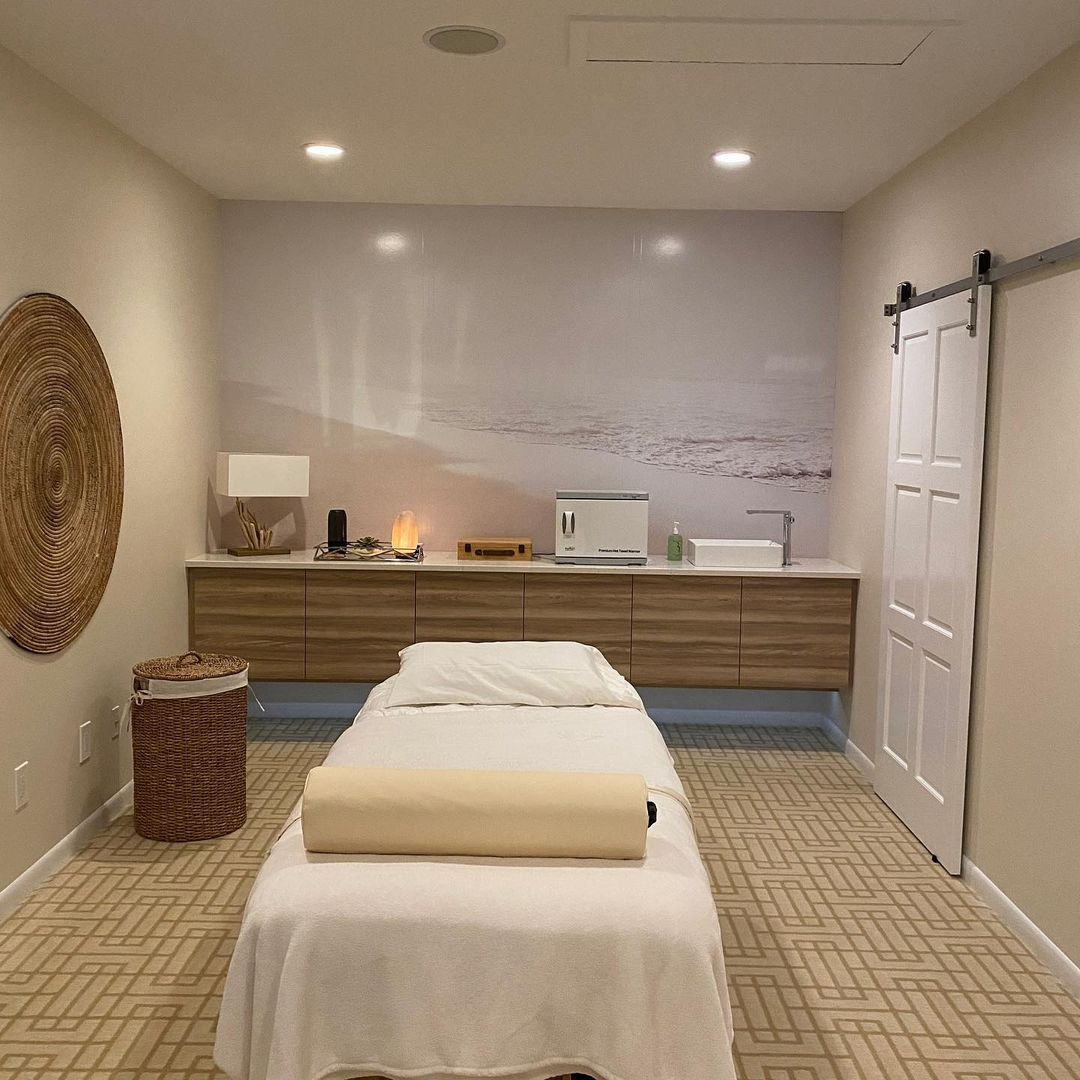 There is a massage table in the middle of the room.
