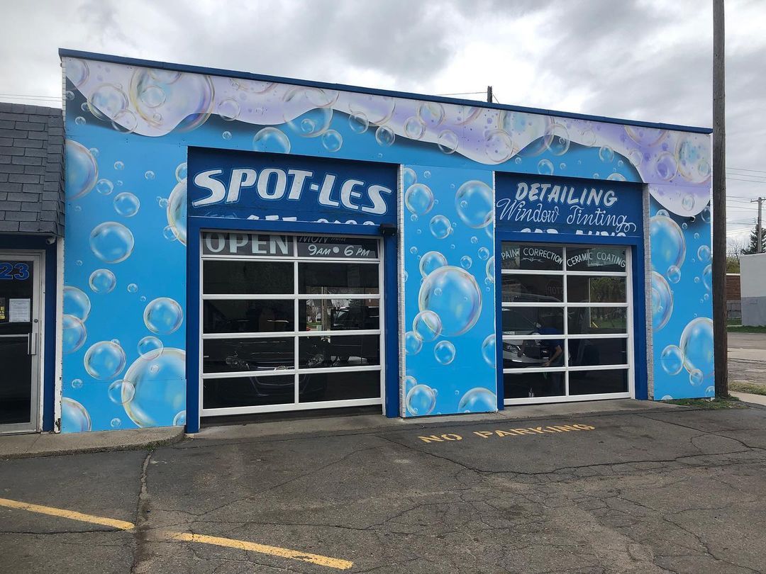 A blue building with bubbles painted on it is a car wash.