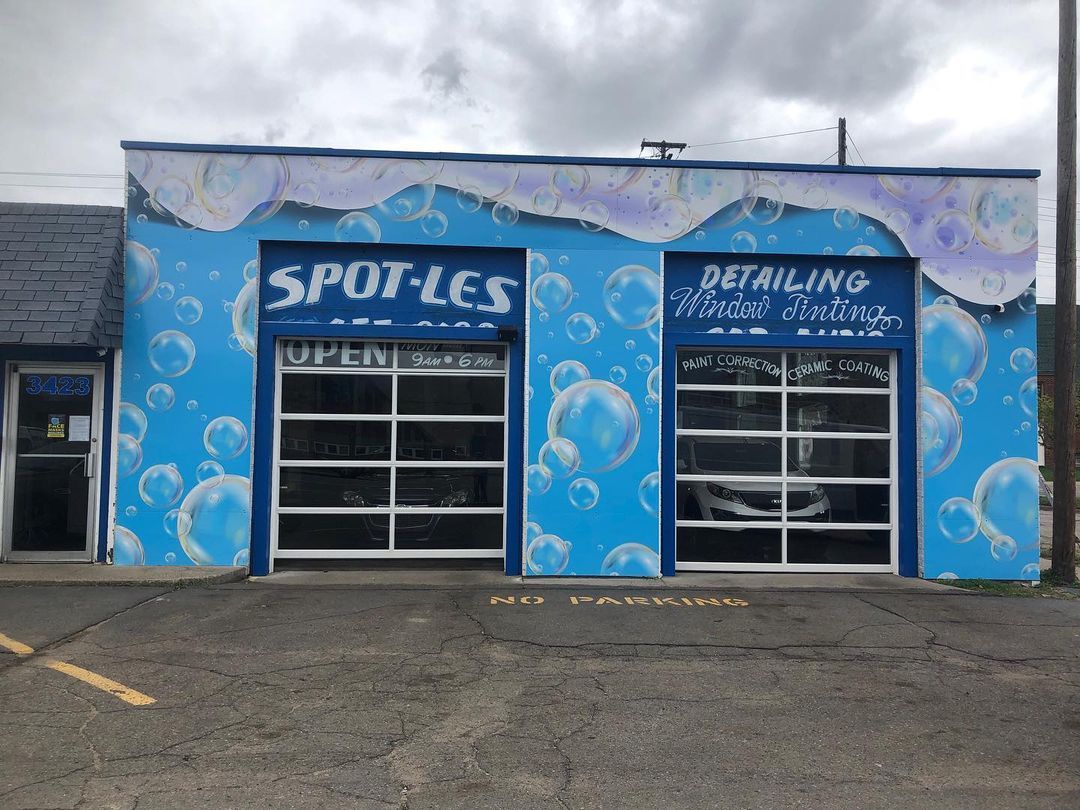 A blue building with a car parked in front of it.