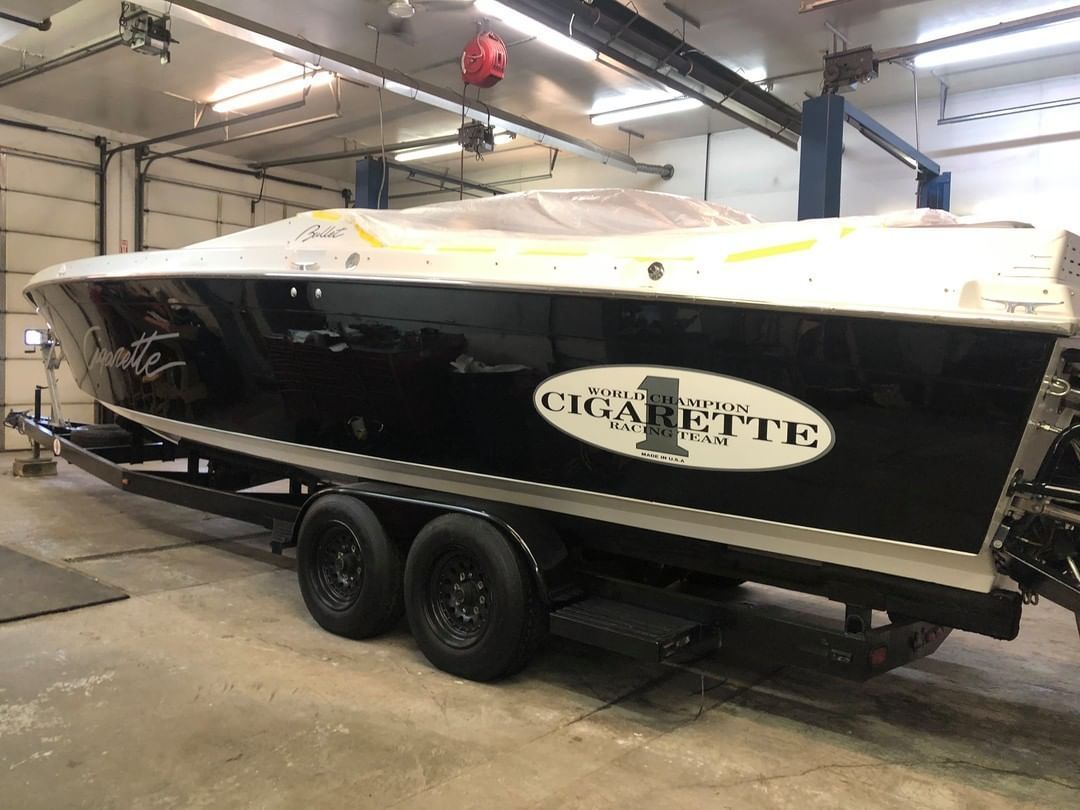 A boat is sitting on a trailer in a garage.