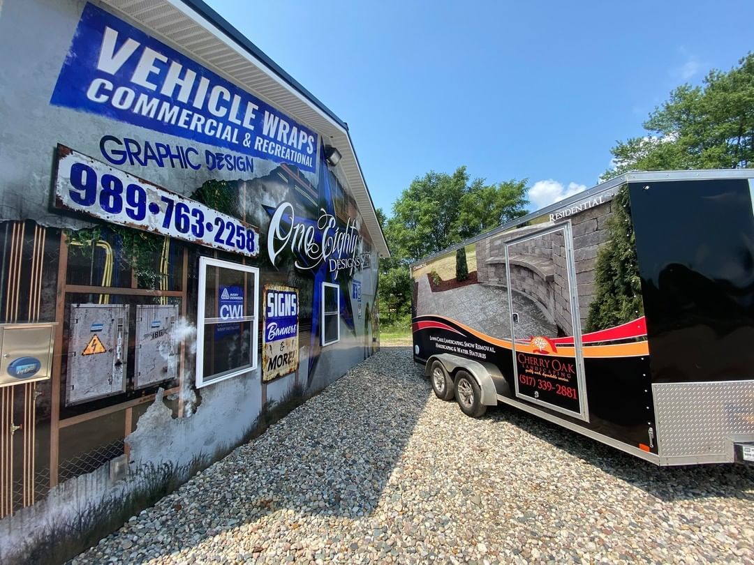 A trailer is parked in front of a building.
