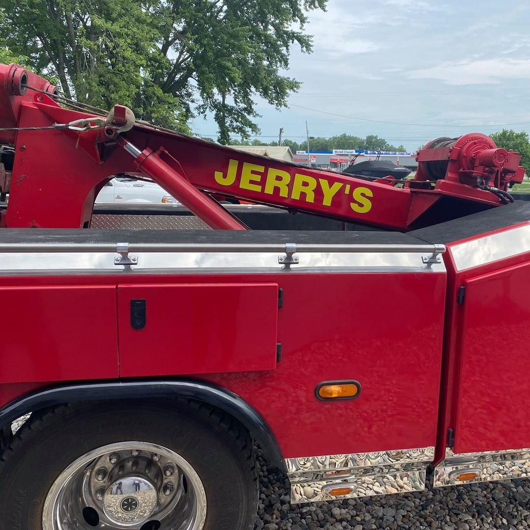 A red tow truck with jerry 's written on the side