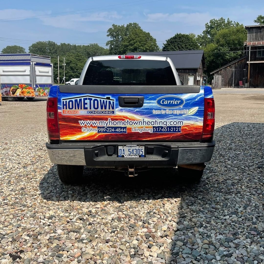 A truck with a sticker on the back that says hometown