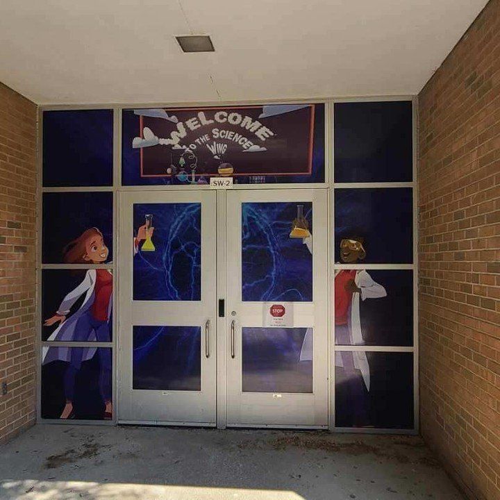 A brick building with a welcome sign on the door