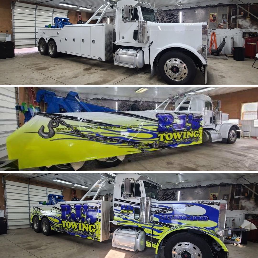 A towing truck is parked in a garage.