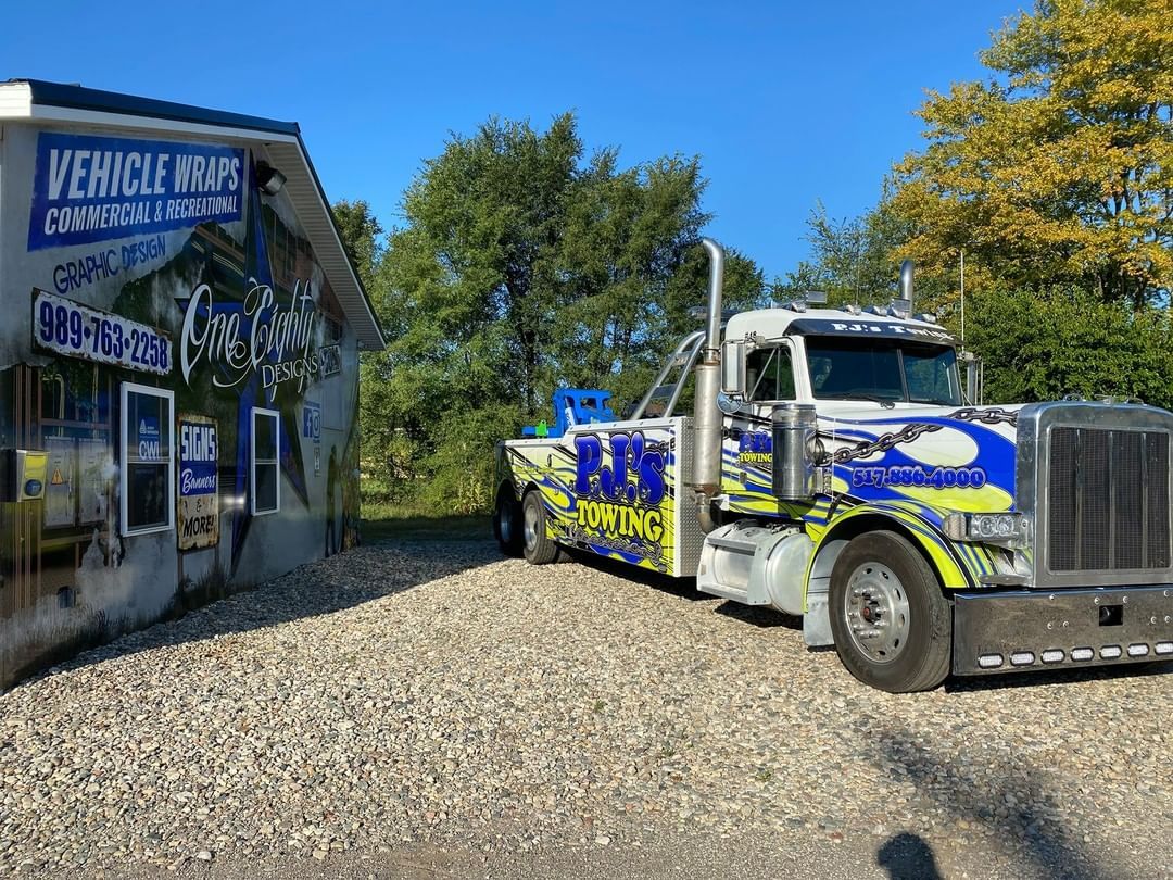 A tow truck is parked in front of a building.