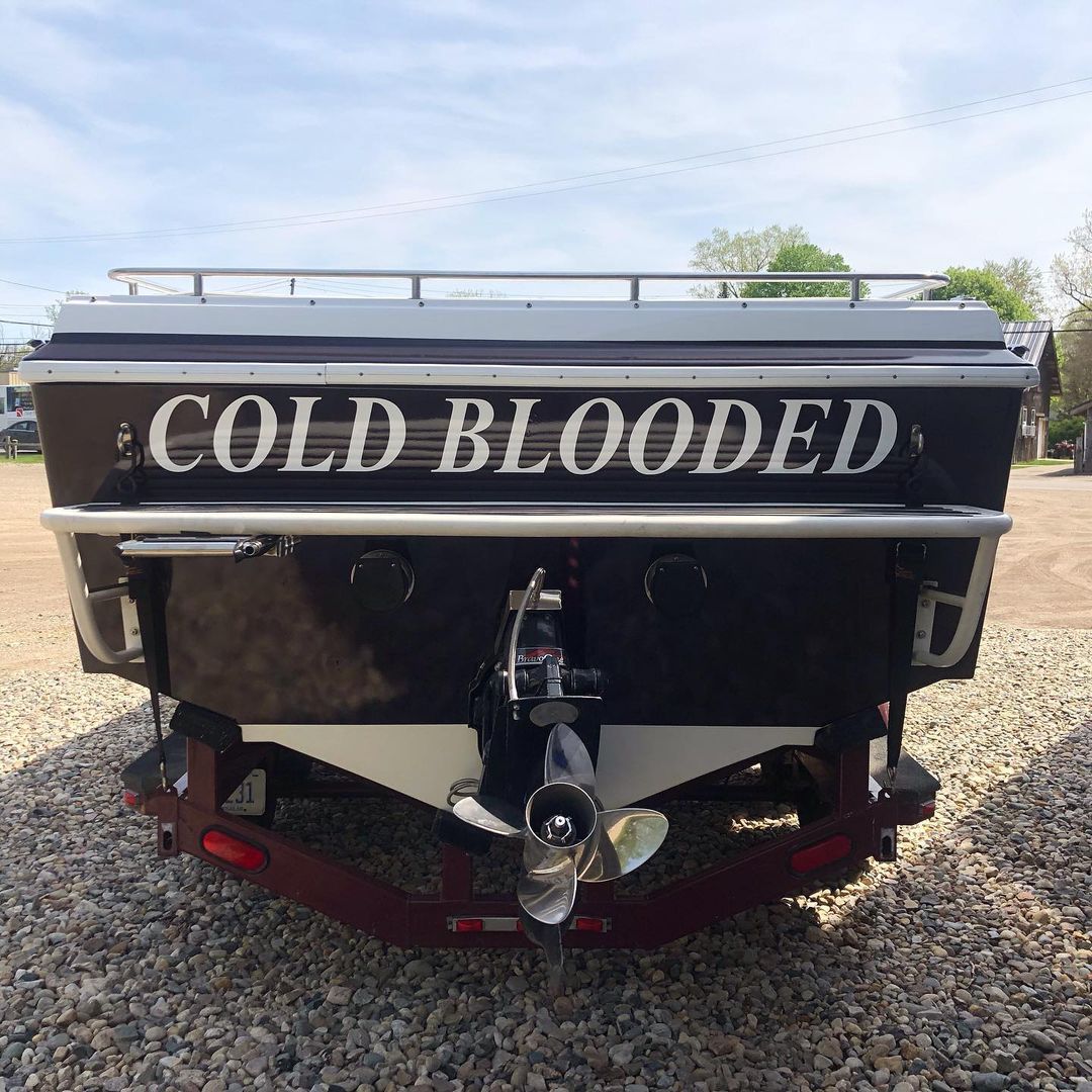 The back of a boat that says cold blooded on it