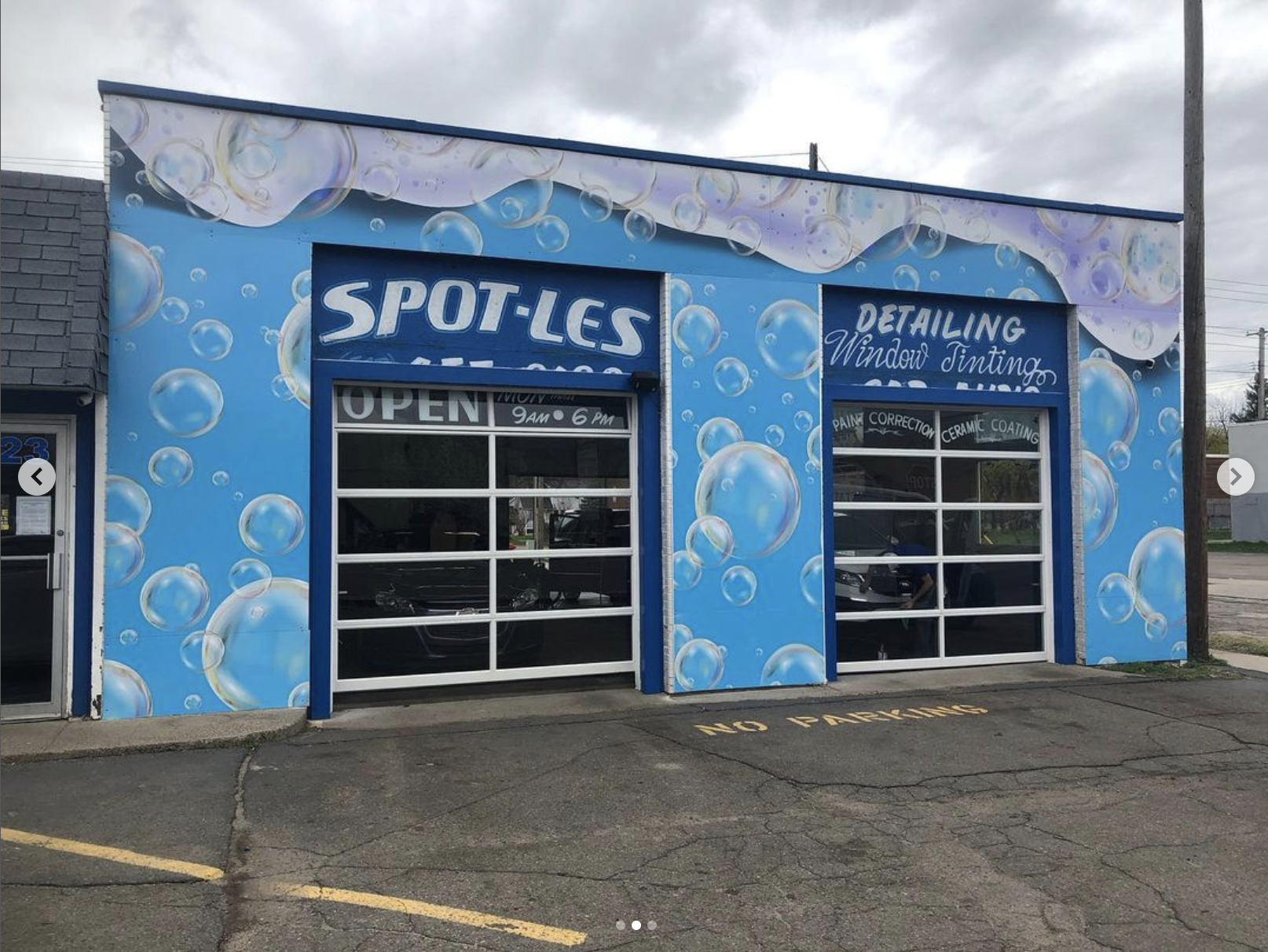 A car wash with a mural on the side of the building.