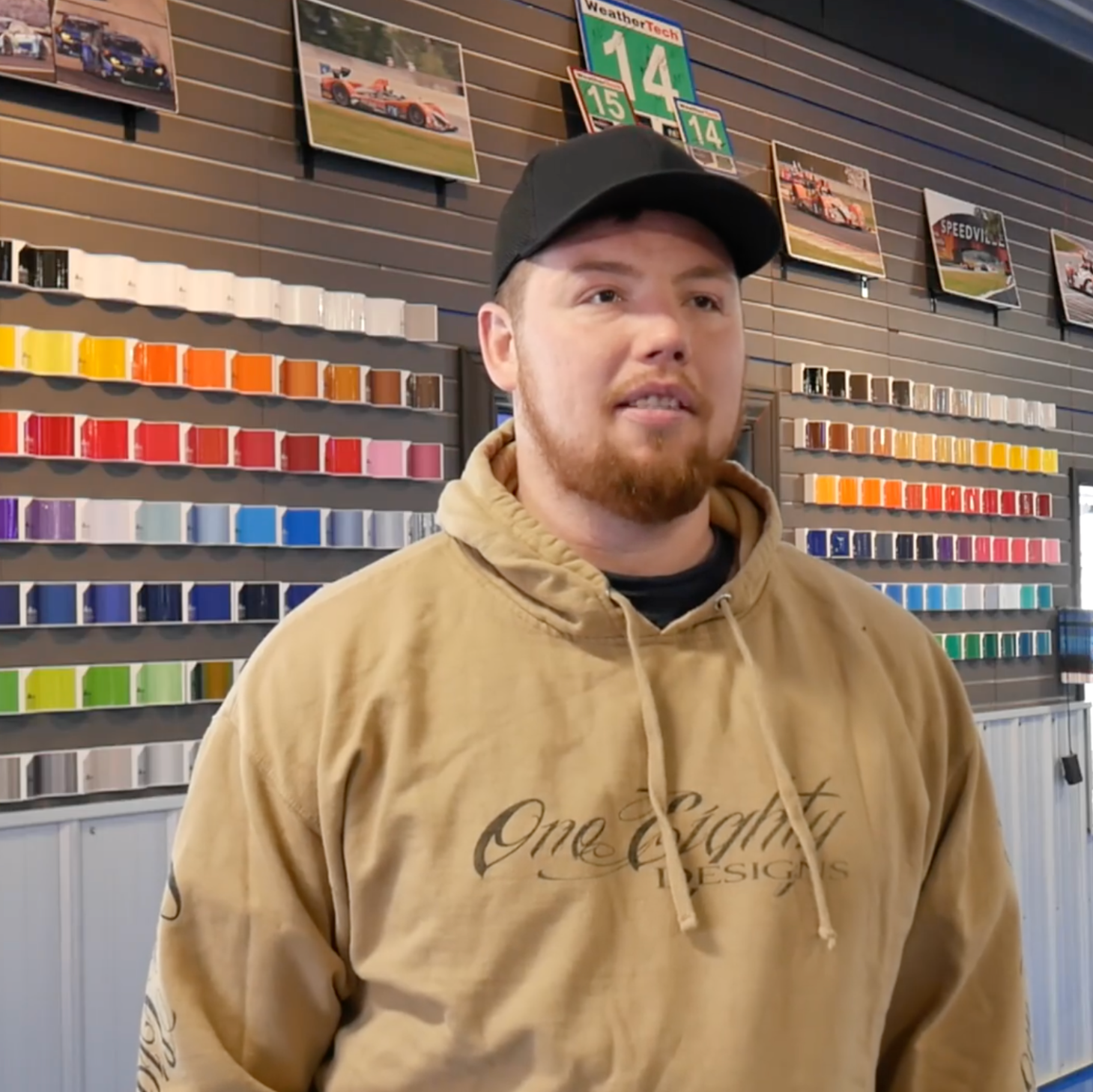 A man wearing a hoodie that says one eighty