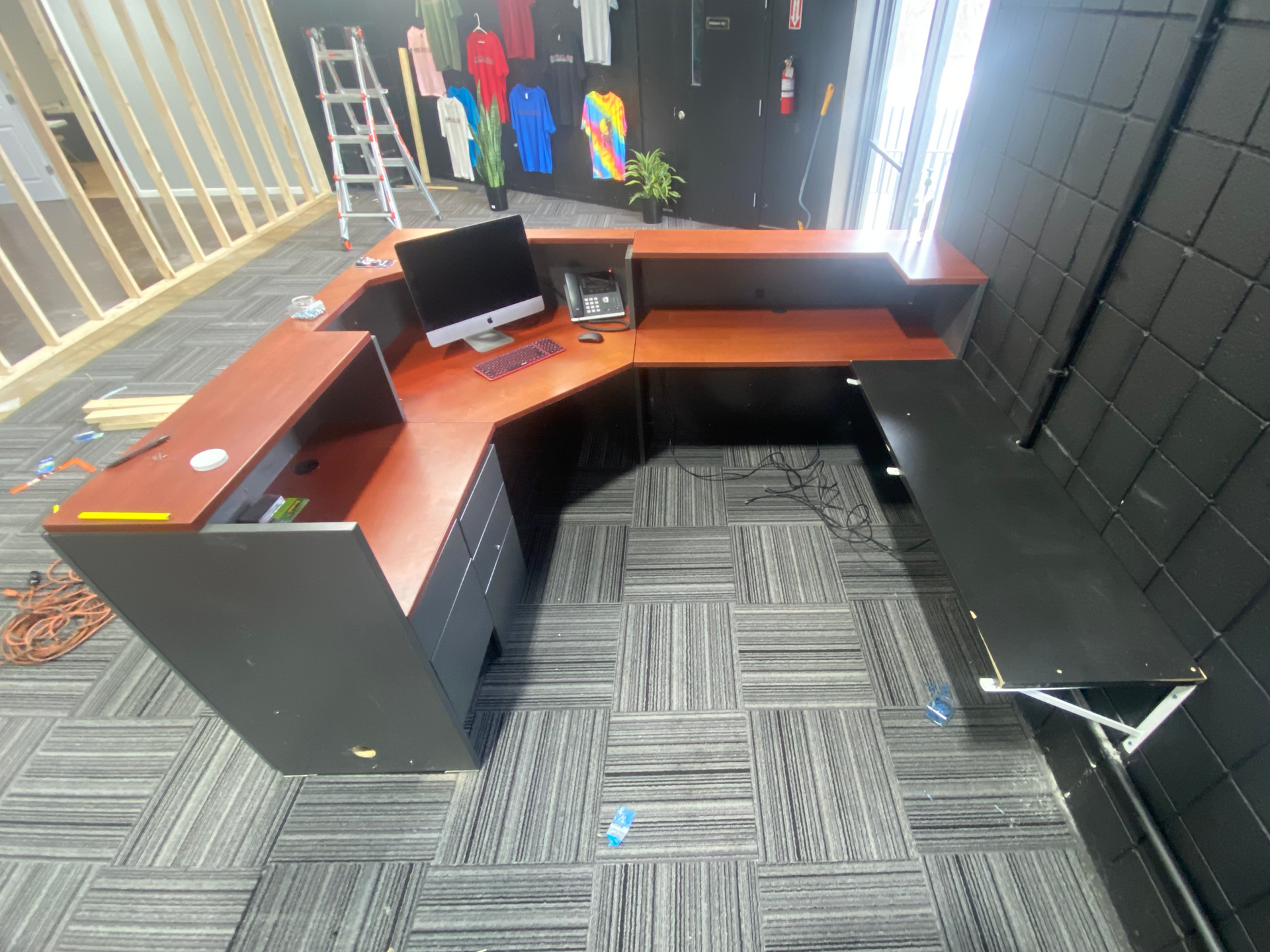 A reception desk with a computer on it in a room.